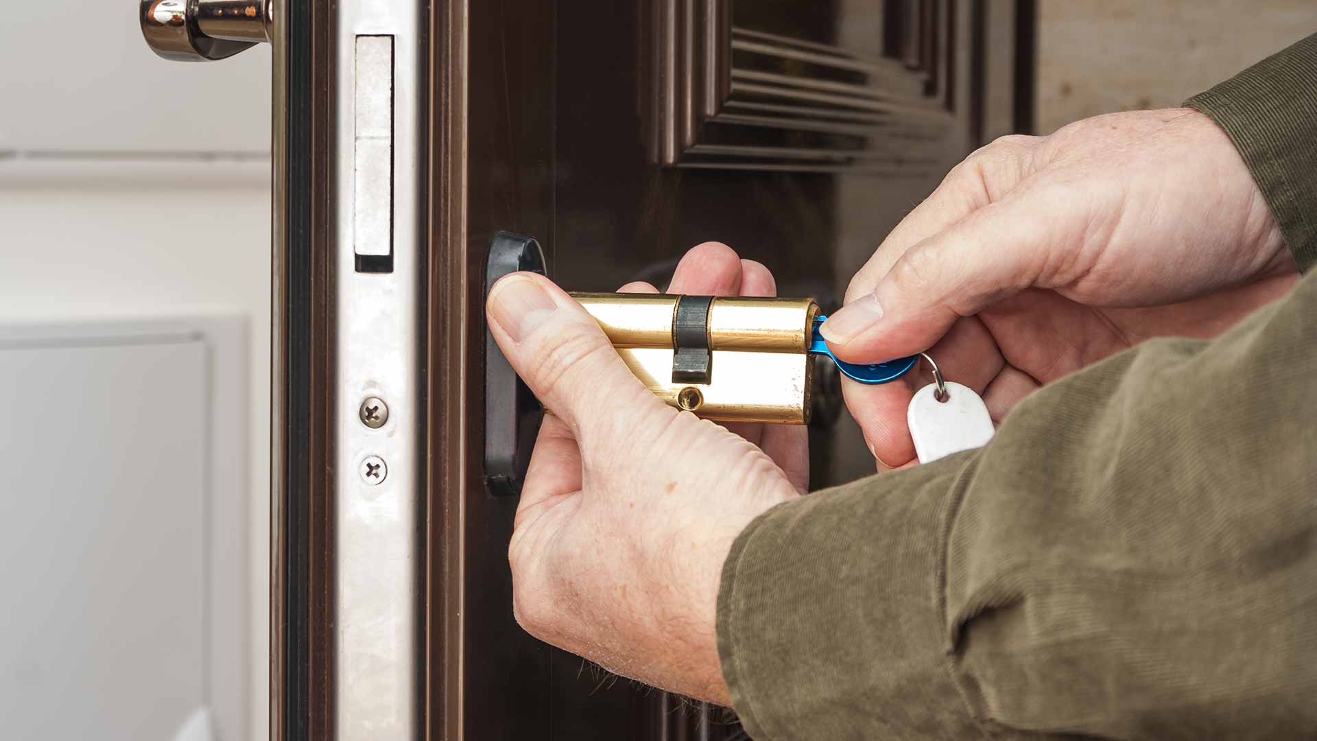 Locksmith re-programmed a smart key and is handing it to a client in Long Island, NY.