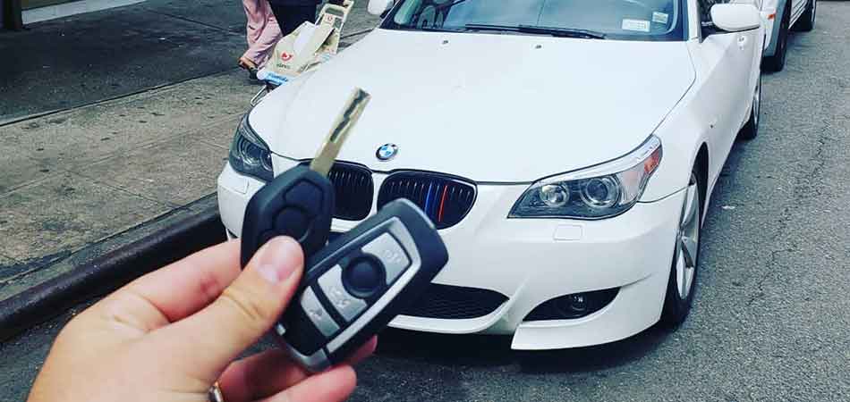 Queens BMW owner holding a newly replaced key by Sonic Locksmith.