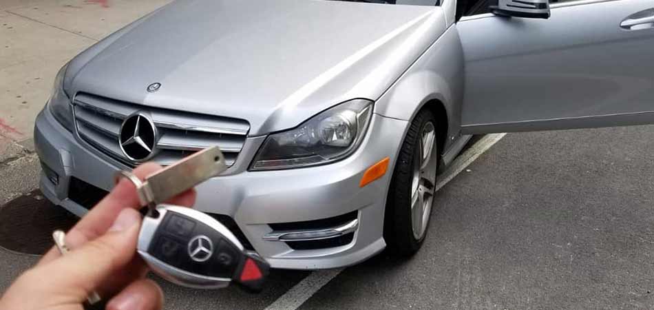 Mercedes owner in Long Island holding a newly replaced key.